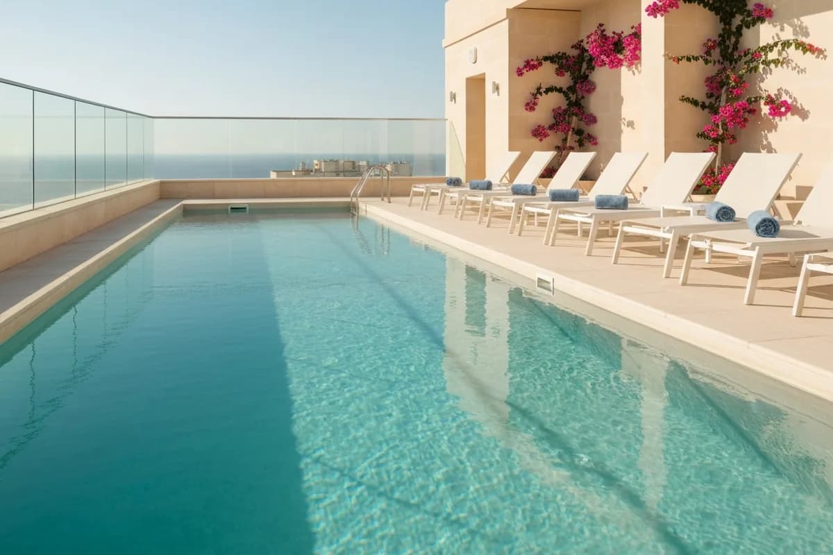 Spacious fitness gym in St Julian's, Malta, featuring kettlebells, gymnastics rings, and an open layout for diverse workouts.