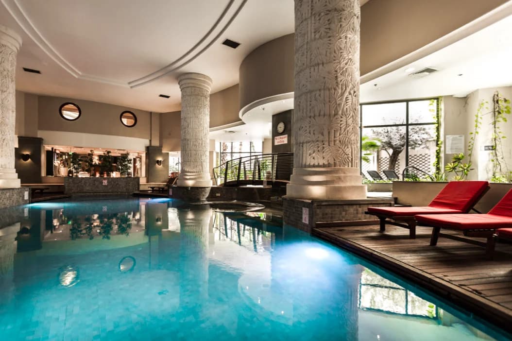 Indoor pool with white drapes at Myoka Lotus Spa, among the luxury spas and wellness centres in St Julian's, Malta.