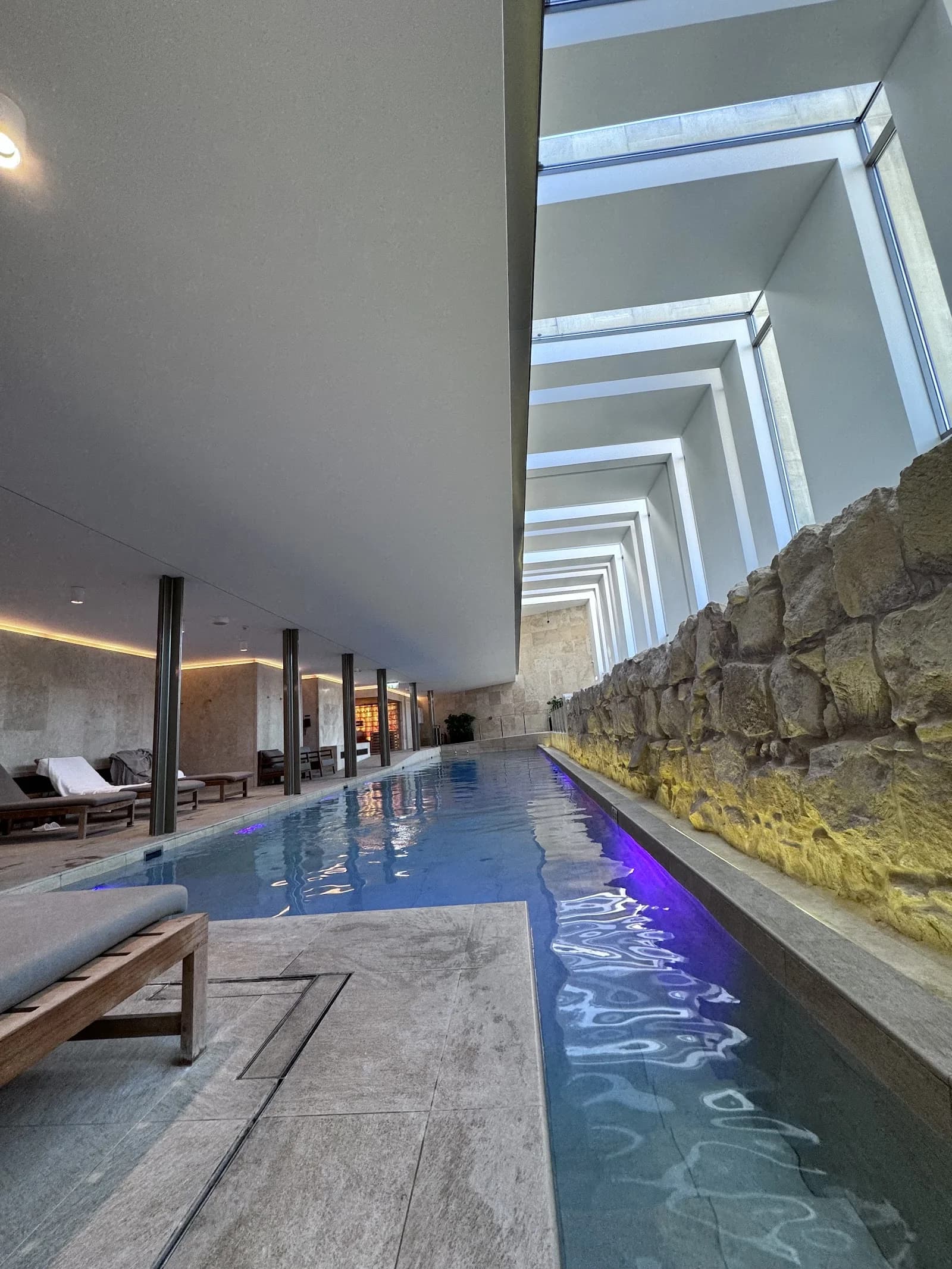 Outdoor pool and luxurious daybeds at Phoenicia Spa & Wellness in Floriana, Malta, a serene setting for spas and wellness...