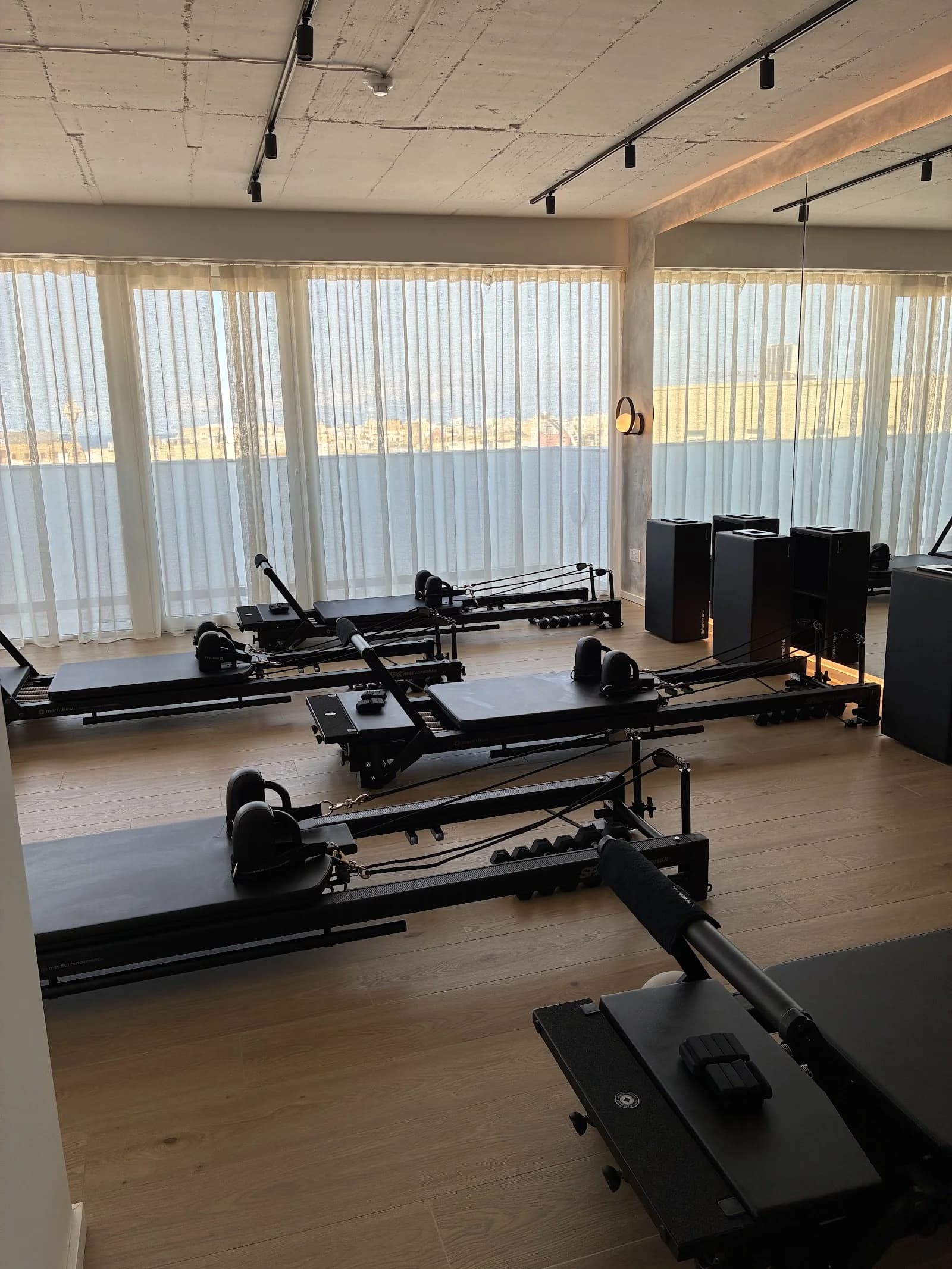 Rolled yoga mat on a sunny wooden deck overlooking the Mediterranean Sea and cliffs, ideal for yoga and pilates in...