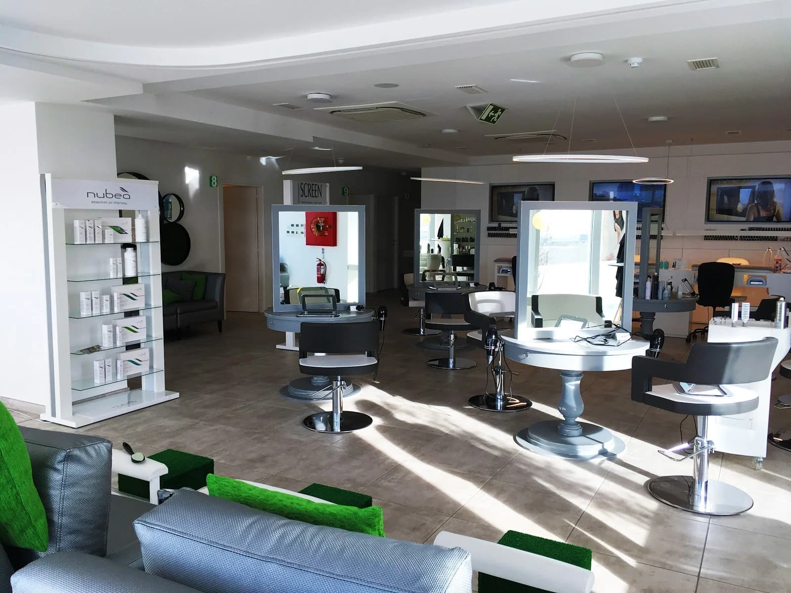 Stylish marble counter with hairbrushes and backlit mirror for beauty treatments in Birkirkara, Malta.